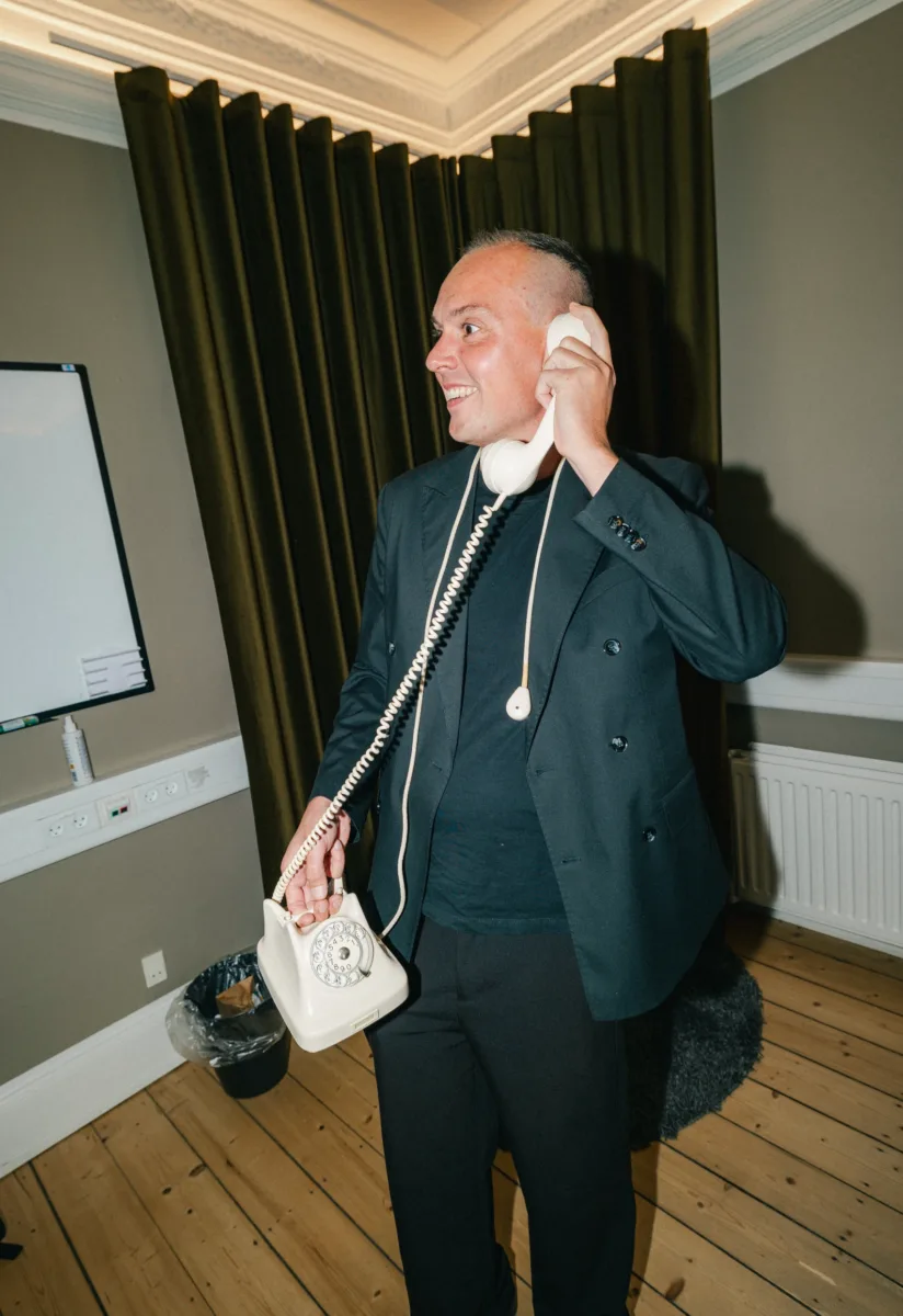 Medarbejder med hovedtelefoner arbejder på en bærbar computer siddende på gulvet